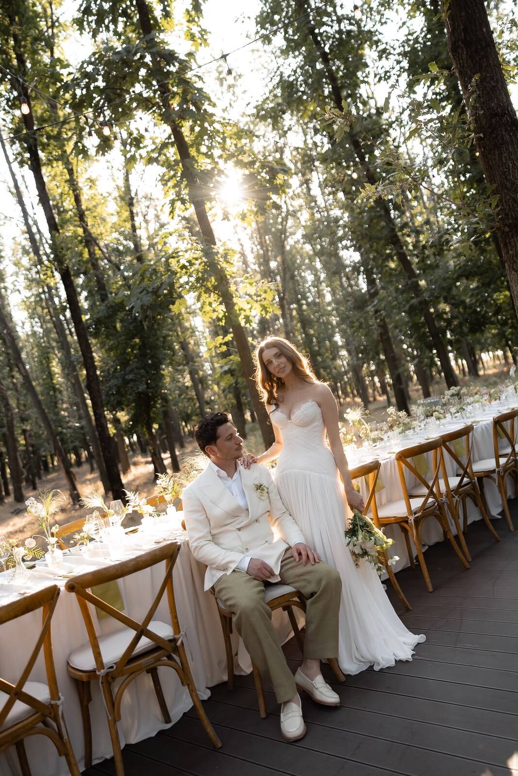 A couple beside their reception table, dressed for their destination wedding